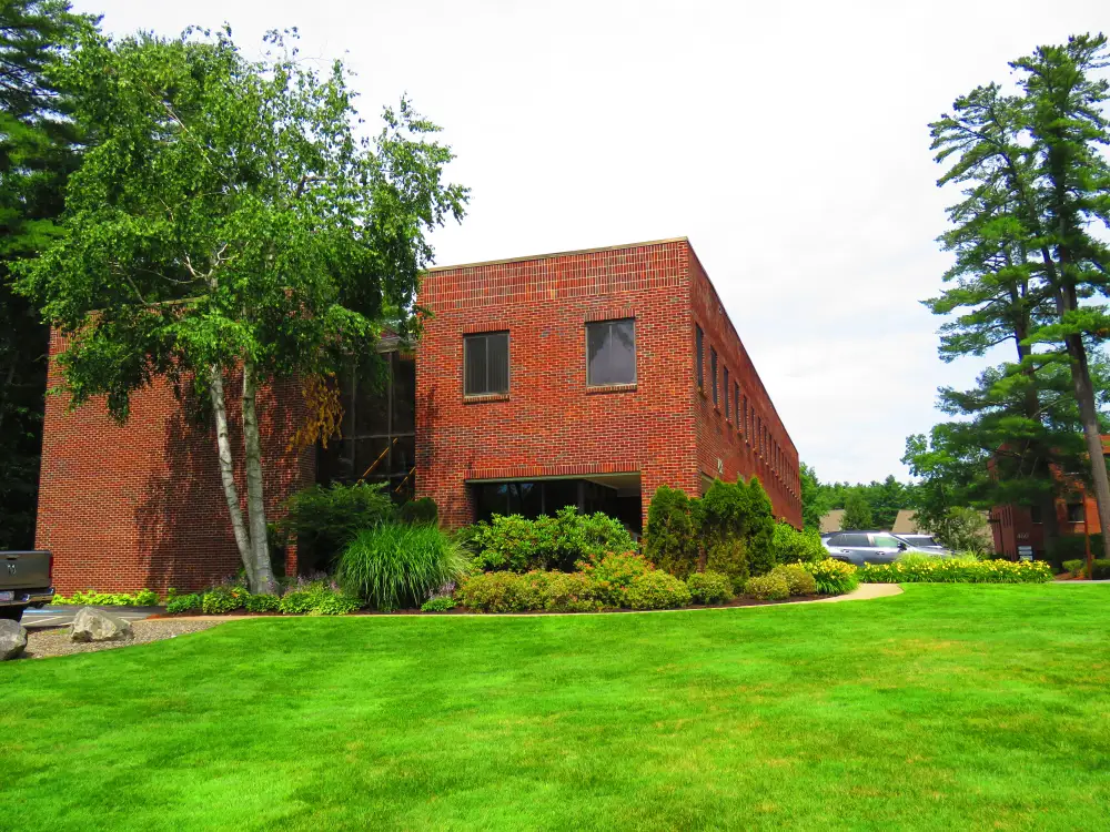 The two storey red brick building at 458 Boston Street, Topsfield, seen from the lawn.